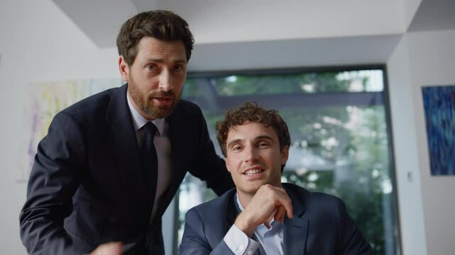 Office men talking virtual meeting using computer online at coworking pov view