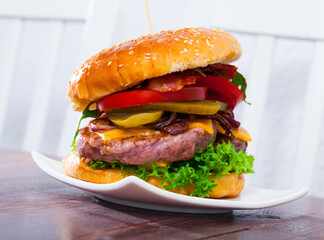 Image of double hamburger with beef, tomato, cheese, cucumber and lettuce