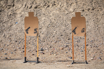 Cardboard targets ready for gun practice, outdoor shooting range in California