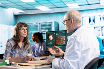 Senior healthcare medic sharing his expertise and interpreting the MRI scans results, offering...