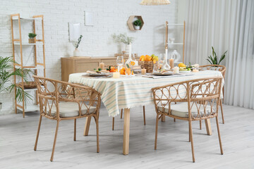 Dining table served with citrus fruits in room