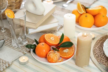 Fotobehang Plate with tangerines on served table for dinner in room. Closeup © Pixel-Shot