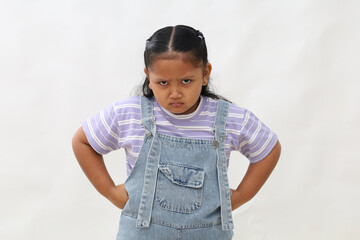 Angry little asian kid showing frustration and disagreement. Isolated on white background