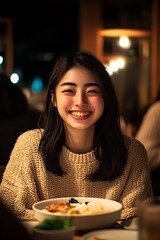 Cheerful young woman smiling brightly while enjoying a delicious meal in a cozy restaurant setting : Generative AI