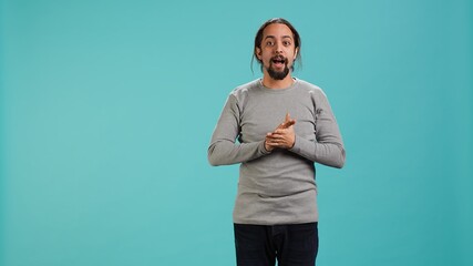 Disappointed man admonishing friend over debacle, isolated over blue studio background. Upset...