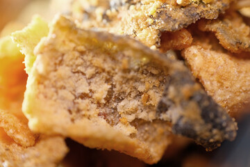Close up texture of crispy fried salmon skin coated with salted egg powder