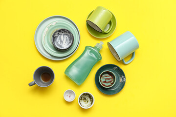 Dirty dishes and detergent on yellow background. Top view