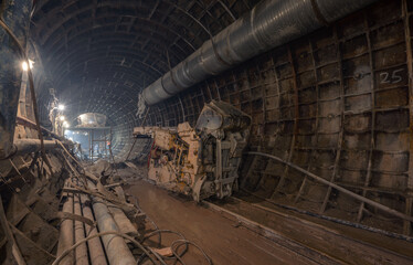 Metro construction, underground works in tunnel. Mine machine