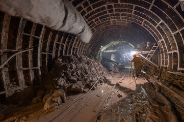 Construction of the subway, welding work in the underground tunnel