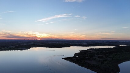 Fototapeta premium Aerial view of orange sunset over the lake