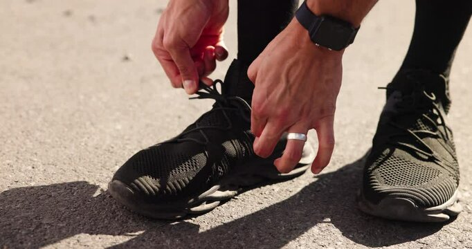 Man, hands and tie laces for fitness preparation, outdoor and active shoes for running. Fingers, road and person with legs for exercise in countryside, sneakers and getting ready for workout start