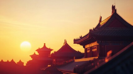 Naklejka premium A dramatic golden sunset over a traditional Chinese temple with intricate roof details and warm hues