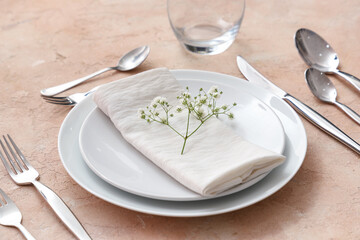 Stylish table setting on beige background. Closeup