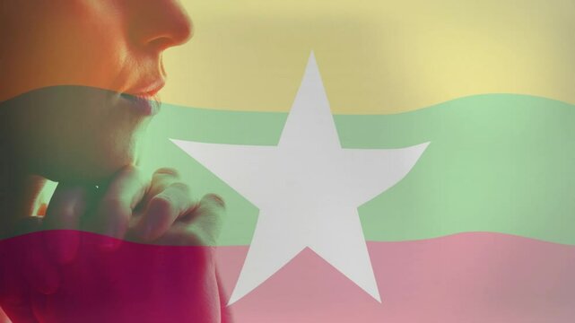 Myanmar flag colors and white star overlaying profile of person in animation