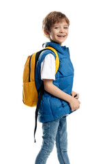 Happy blonde boy sitting on yellow skateboard and holding notebook on white background. Back to School.