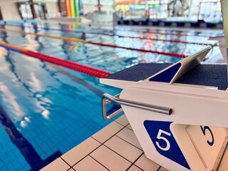 Swimming pool with starting blocks