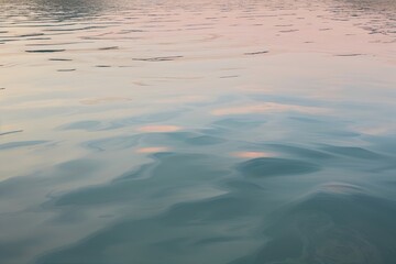 Fototapeta premium Tranquil Water Surface Showcasing Muted Pastel Shades and Serene Reflections