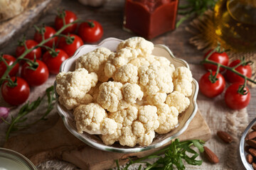 Cauliflower, tomatoes, arugula, olive oil - ingredients for homemade gluten-free pizza