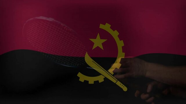 Holding tennis racket over Angola flag, hand showing support for sports animation