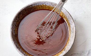 bowl of homemade hoisin sauce on white kitchen table