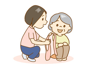 高齢者の生活の支援、上着を着るように勧める介護士