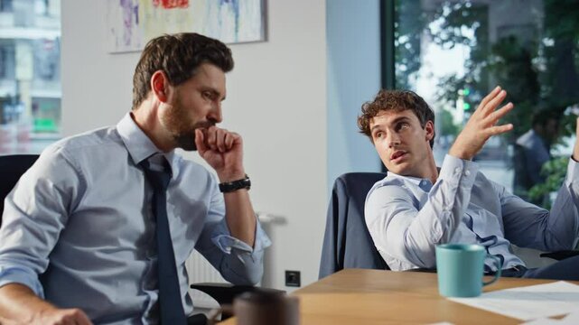 Two startupers having conversation sitting office at break closeup. Men talking