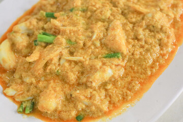 Stir Fried Crab in Curry Powder Sauce with Eggs, garlic, pepper, onion, vegetables. Thai seafood...