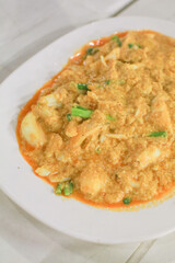 Stir Fried Crab in Curry Powder Sauce with Eggs, garlic, pepper, onion, vegetables. Thai seafood Food and Asian fusion style. 