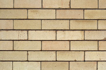 Fototapeta premium Light brown brick wall abstract textured background close-up