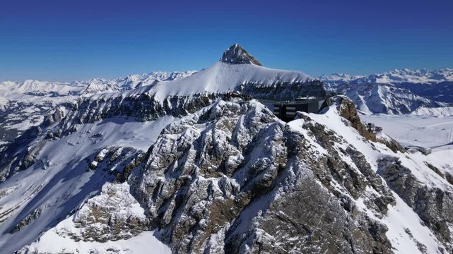 Panoramic Aerial View of Glacier 3000 with Alpine Peaks, Suspended Bridge (Peak Walk), Cable Car Lift, and Ski Resort at the Summit in Switzerland