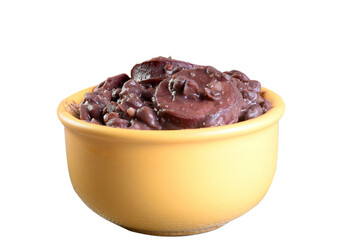delicious Brazilian feijoada with farofa rice salad served in bowl over piece of wood on blurred background, Brazilian food