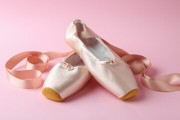 Pair of beautiful pointe shoes on pink background © New Africa