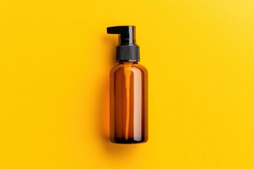 Naklejka premium Amber Bottle Pump Dispenser Yellow Background.