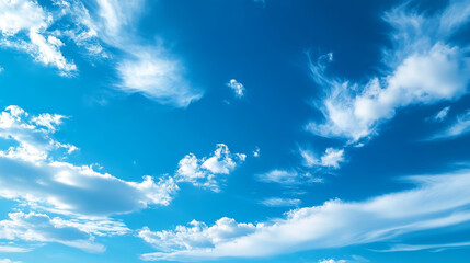 Bright blue sky with fluffy white clouds creating serene atmosphere. clouds vary in shape and size, enhancing beauty of clear day