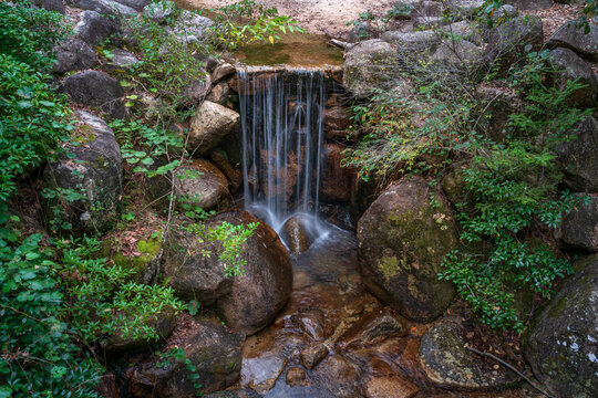 Waterfall on the Momijidani River in the park of the same name on Miyajima Island on an autumn day, Hatsukaichi, Hiroshima Prefecture, Japan