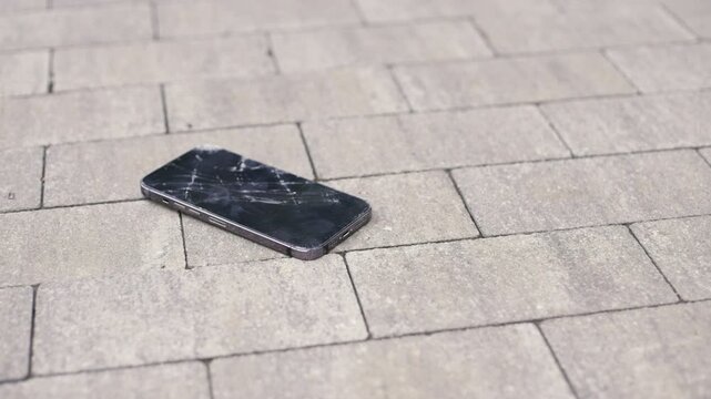 Modern smartphone crashing on asphalt slow-motion Close-up 4K UHD B-Roll footage