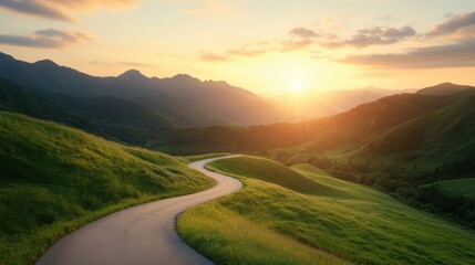 Winding asphalt road through green hills and mountains at sunset.