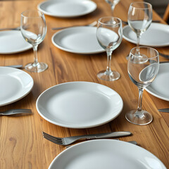 Several white plates and clear glass glasses are placed on a wooden table.