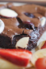 Deliciously baked brownie with fresh strawberries and cream