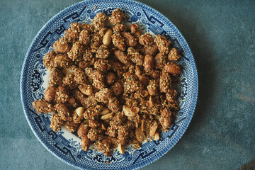 Crunchy spiced nuts served on a decorative plate