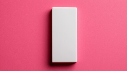White polymer eraser rests, clean beveled edge on pink, ready for mistake removal