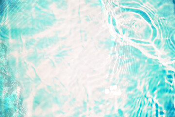 Blue water with ripples on the surface. Defocus blurred transparent blue colored clear calm water surface texture with splashes and bubbles. Water waves with shining pattern texture background.