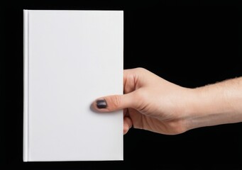 Obraz premium Hand holding blank white hardcover book on black background with index finger pointing, glossy finish, isolated on right side.