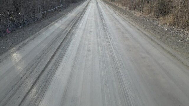 Fast low-level overflight of a wet dirt road - Survol rapide &agrave; basse altitude d'une route de terre humide