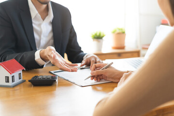 Asian landlord calculate price, client or tenant hand sign contract rental purchase buyer home with...