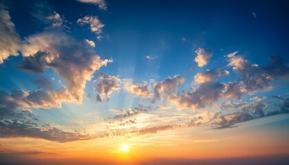 gentle colors of real sundown sunset sky with beautiful light clouds and sun