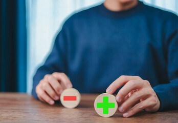 
Businessman showing plus icon, concept of comparing pros and cons, helps to make decision about...