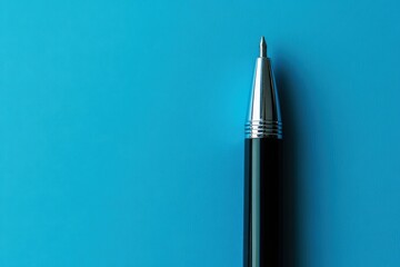 A shiny pen stands against a bright blue background