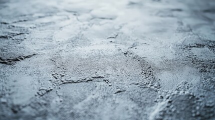 Fototapeta premium Close-up of a gray, textured surface: wet with rough patches. Half encased in glistening ice, the other half reveals its rugged depth, inviting curiosity