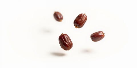 Big dates isolated. Dry date fruits heap, medjool, medjoul or majhool, royal dates with green leaves on white background